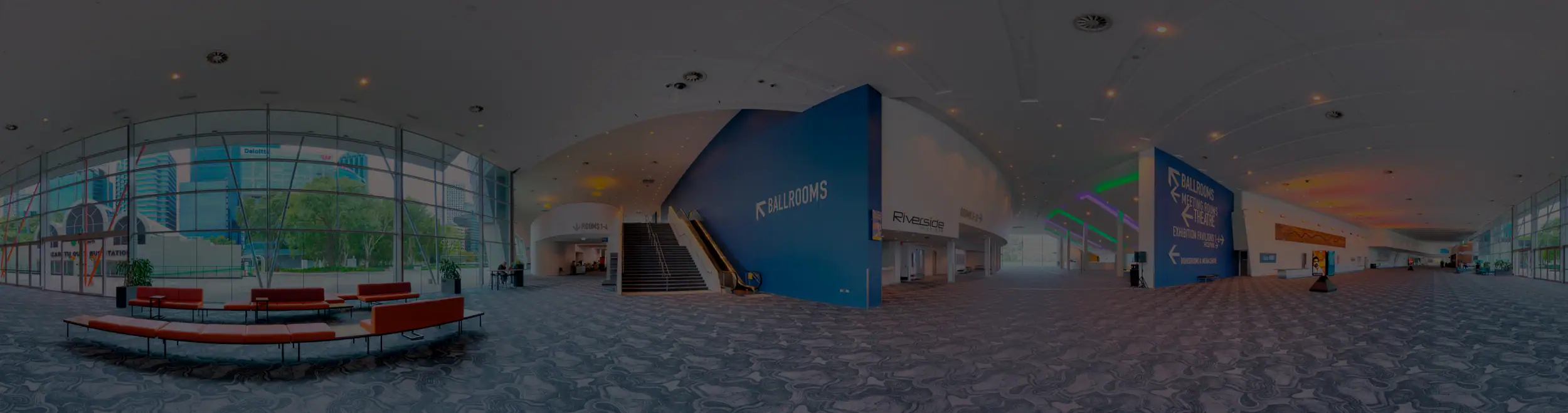 Indoor view of well-designed conference lobby with floor-to-ceiling windows, showcasing WellStrategic's Virtual Tour expertise.